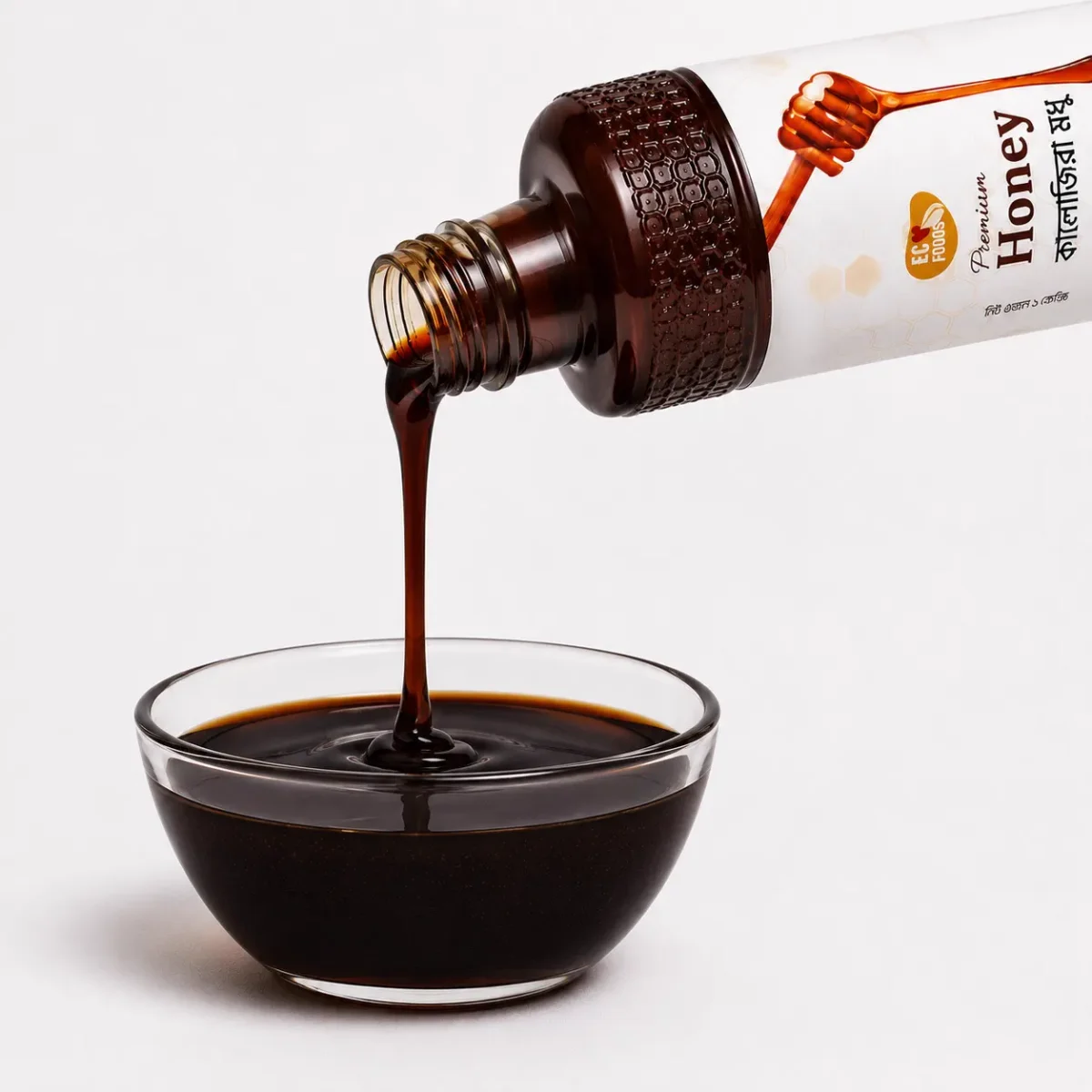 Black Seed Flower Honey bottle pouring into a glass bowl - Eco Foods