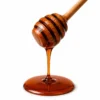 Black seed honey dripping from a wooden dipper - Eco Foods