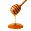 Mustard flower honey dripping from a wooden dipper - Eco Foods