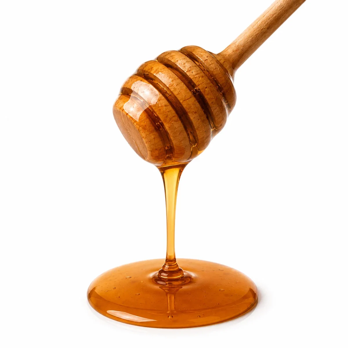 Mustard flower honey dripping from a wooden dipper - Eco Foods