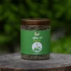 Pudina Mint Tea 50 G jar on a wooden stump outdoors - Eco Foods
