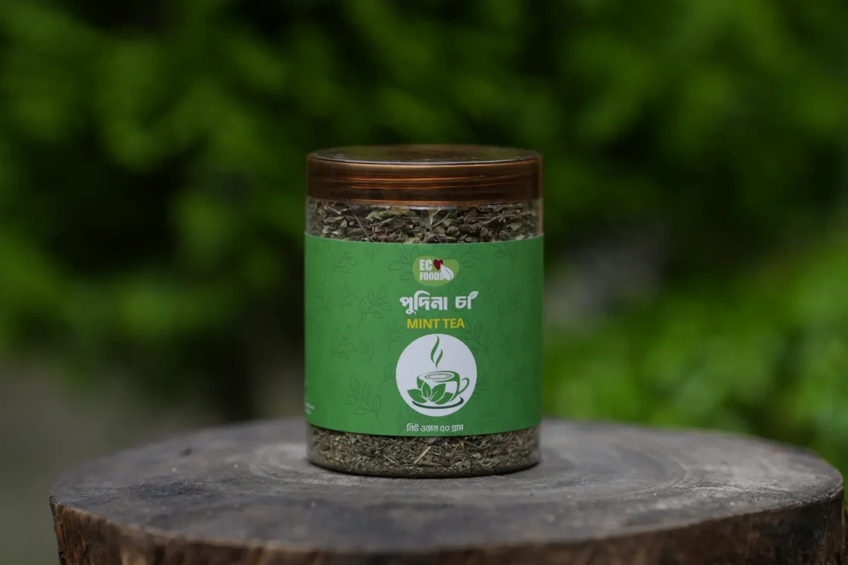 Pudina Mint Tea 50 G jar on a wooden stump outdoors - Eco Foods